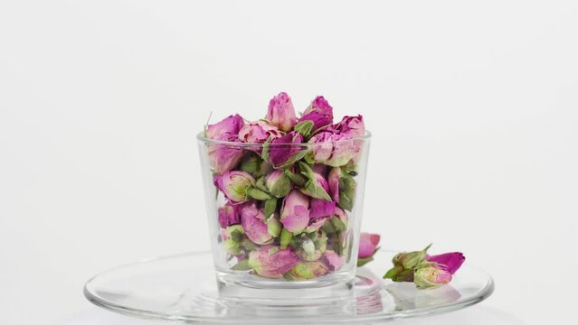 Rose buds in glass on the white background.