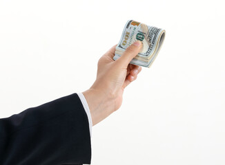 A hand bribing a bundle of 100 dollar bills