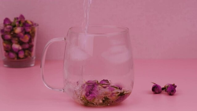 Making Flower tea from the Rose buds in glass cup.