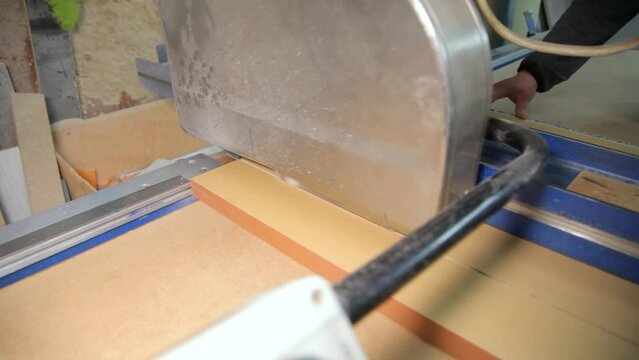 Cutting chipboard for furniture. Manufacture of wooden furniture. Cutting wood board for furniture making - editorial footage