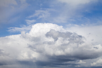 Naklejka na ściany i meble Blue sky with cumulonimbus clouds. View from the ground.