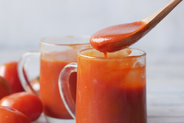 tomato sauce in a jar with fresh tomato on table 