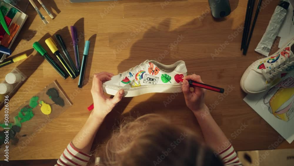 Poster top view of female designer creating hand made shoe while drawing on it at home. woman working aroun