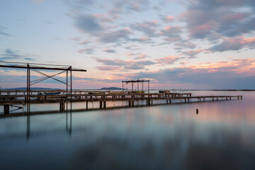 Fototapeta na wymiar Wooden piers and boats for the oyster farm in Etang de Thau in South France