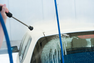 Close-up of the lance of a hose for cleaning vehicles with pressurized water in a self-service car wash.