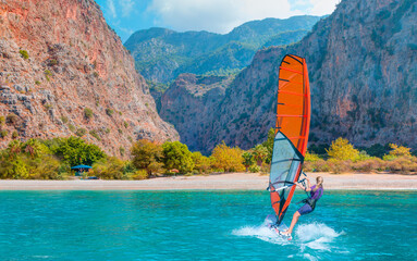 Beautiful cloudy sky with Windsurfer Surfing The Wind On Waves Butterfly beach Valley - Oludeniz, Fethiye