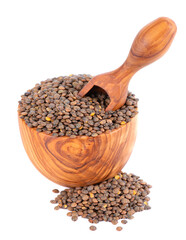 French lentils in olive bowl and spoon, isolated on white background. Dry puy lentil grains pile.