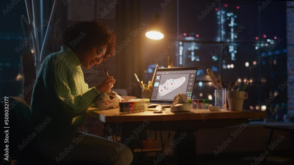 Poster active female designer sitting at evening in loft studio and working on shoes customisation. living 
