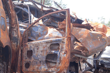 car graveyard. Burnt and blown up car. Cars damaged after shelling from russian invasion. War between Russia and Ukraine. Terror attack bomb shell. Disaster area irpin bucha