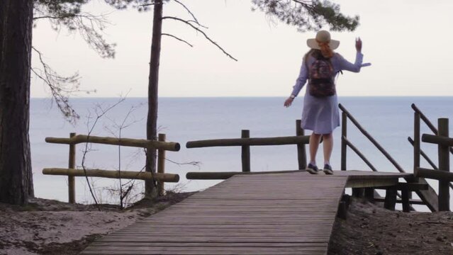 Charming pretty lady letting go freely dancing on deck in Sweden 