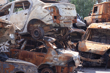 car graveyard. Burnt and blown up car. Cars damaged after shelling from russian invasion. War between Russia and Ukraine. Terror attack bomb shell. Disaster area irpin bucha