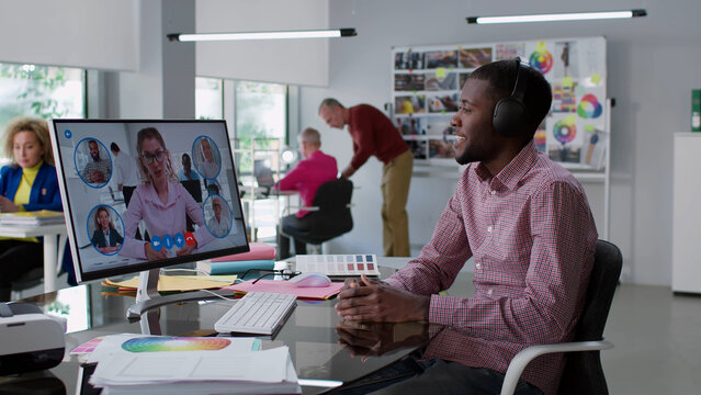 African-American editor having video conference with publishers on computer  - Powered by Adobe