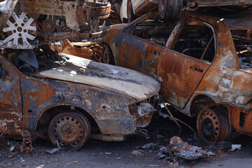 rusty burnt cars in Irpen, after being shot by Russian military and missile. Russia's invasion. war...