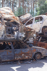 car graveyard. Burnt and blown up car. Cars damaged after shelling from russian invasion. War between Russia and Ukraine. Terror attack bomb shell. Disaster area irpin bucha