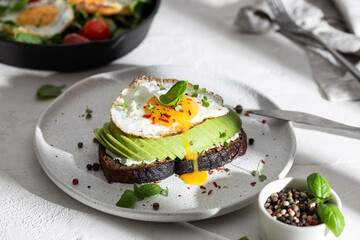 Sandwich with avocado and fried egg