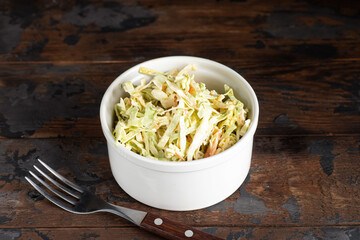 Cabbage salad, cabbage salad with dressing on a wooden background