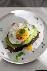 Sandwich with avocado and fried egg