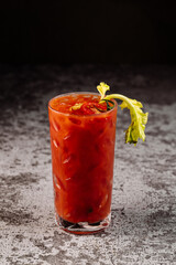 Red alcoholic  tomatoe cocktail on black background