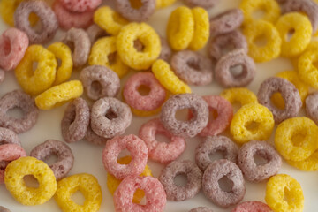 children's dry breakfast colored corn rings on a white background with a place for text