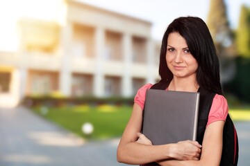 Obraz premium A brainstorming clever student hold netbook posing