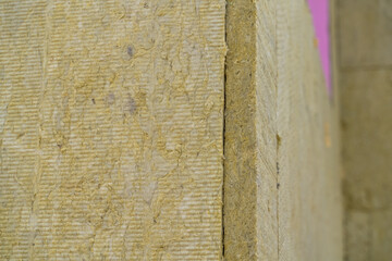 Layer of thermal insulation on the wall of the house outside. Mineral wool panels.