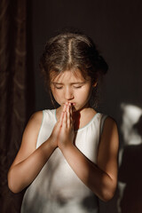 A little girl folded her hands in prayer in the hope of ending the war in Ukraine, a Ukrainian...