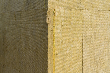 Layer of thermal insulation on the wall of the house outside. Mineral wool panels.