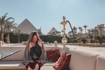 Woman with view over the Pyramids of Giza from the hotel of Marriott.