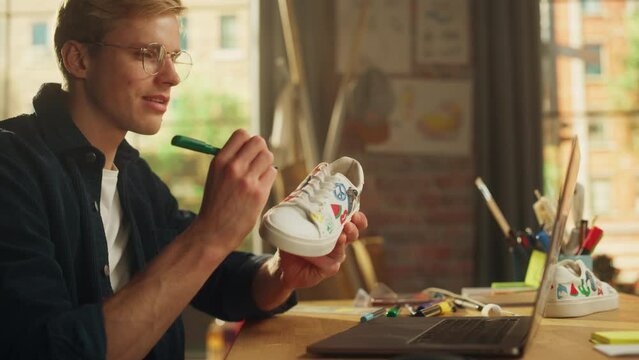 Teenage Male Artist Customising Footwear by Painting on it at his Workplace. Creative Freelancer Making Organic Design Shoes. Millennial People Concept