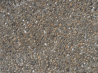 grey pebbles set into concrete texture background