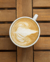 Cup of cappuccino on the table in a cafe, top view
