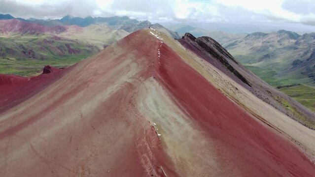 Aerial landscape of Rainbow Mountain Peak at Vinicunca Valley in Peru. A mountain with intense red, yellow, orange, green and blue colors. Red Valley. Scenic view of idyllic landscape.