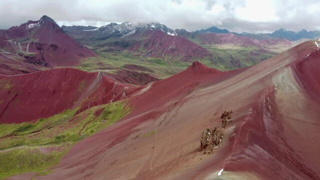 Aerial landscape of Rainbow Mountain Peak at Vinicunca Valley in Peru. A mountain with intense red, yellow, orange, green and blue colors. Red Valley. Scenic view of idyllic landscape.