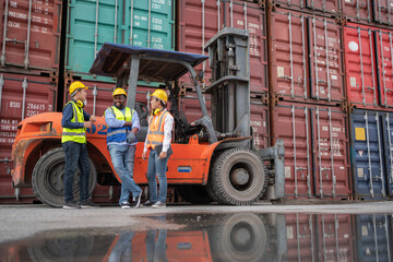 Group of engineer worker standing in front of forklift in the shipping yard container. Talking and rest during break time. Import, export product. Manufacturing transport and global business concept
