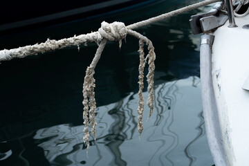 Fototapeta premium Old worn mooring rope of a yacht marine background.
