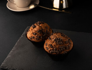 Chocolate muffins for breakfast. Homemade fluffy chocolate cupcakes. Cupcakes with chocolate and cinnamon for coffee