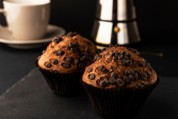 Chocolate muffins for breakfast. Homemade fluffy chocolate cupcakes. Cupcakes with chocolate and cinnamon for coffee