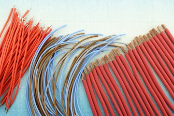 Copper colored tips on a wire on a colored background. Space for text.