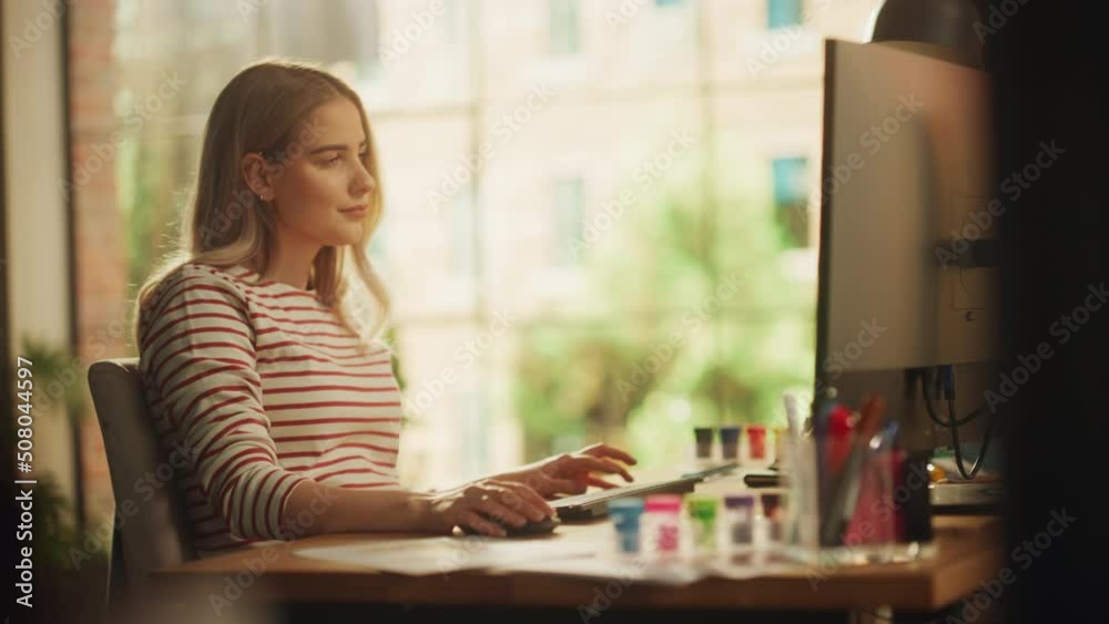 Poster Smiling Caucasian Woman Working on Desktop Computer while Sitting Behind Desk in Loft Living Room. Freelancer Working From Home. Browsing Internet, Using Social Networks