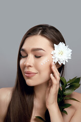 Fototapeta premium Portrait of young and beautiful woman with perfect smooth skin. Concept of natural cosmetics and face skin care.