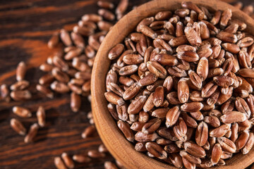 Raw wheat grain in wooden utensils