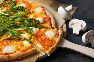 Tasty pizza with tomato, cheese, mushrooms, arugula