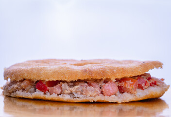 fried arepa with tuna and tomato