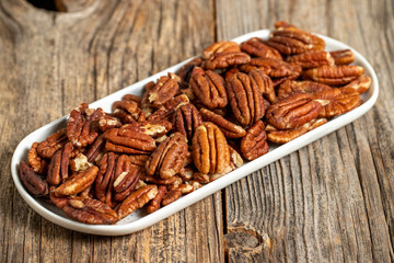 Pecan walnuts on wooden background. close up