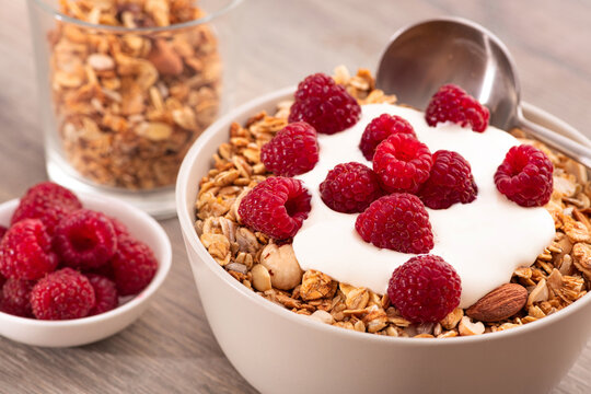 Sweet breakfast with granola, yogurt and fresh raspberries