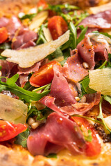 Pizza with prosciutto and arugula. Italian food.