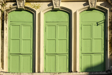 Beautiful ruined vintage wooden windows of an old Chinese shop house in the heritage town of Georgetown in Penang, Malaysia.