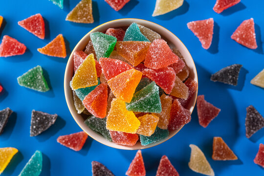 Multicolored sugar jelly sweets on a blue background