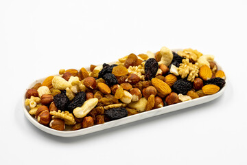 Mixed nuts on white background. Nuts, walnuts, raisins and cashews. close up