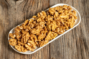Walnut on wooden background. Close-up walnut kernel